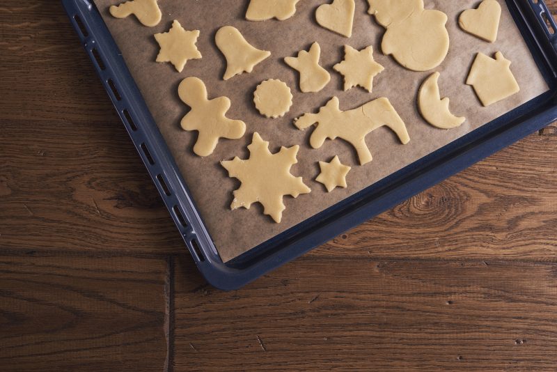 Arrangement of gingerbread cookies on cookie sheet Bake with Shivesh